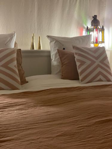 a bed with pillows on it with at Dar El Qadi in Marrakech