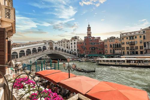 a view of a river with a bridge and buildings at Hotel Marconi in Venice