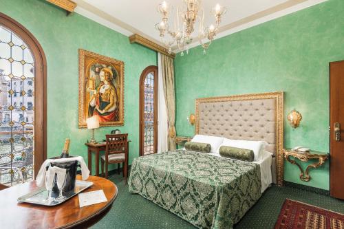 a bedroom with a bed and a table in it at Hotel Marconi in Venice