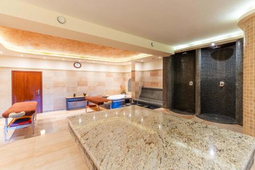 a large bathroom with a large tub in a room at Hotel Dziki Potok Karpacz Konferencje & SPA in Karpacz