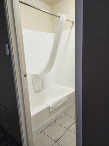 a bathroom with a bath tub with a towel at Quality Inn I-70 at Wanamaker in Topeka