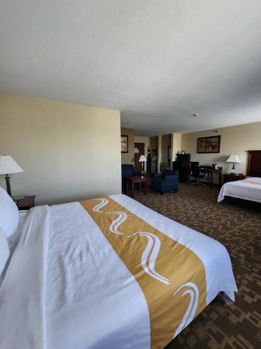 a hotel room with a large bed in a room at Quality Inn I-70 at Wanamaker in Topeka