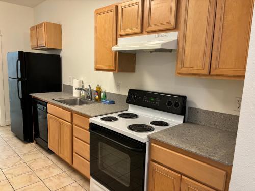 a kitchen with a black and white stove and a sink at Downtown Portland Cozy Studio in Portland