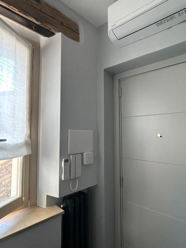 a bathroom with a shower door and a window at Vecchio Calzaturificio Verducci in Montegranaro