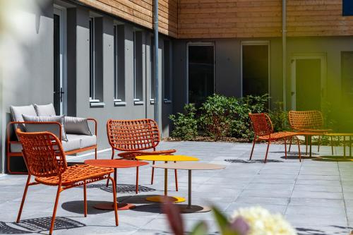 a group of chairs and tables on a patio at Sweetly Versailles St Cyr l'école in Saint-Cyr-lʼÉcole