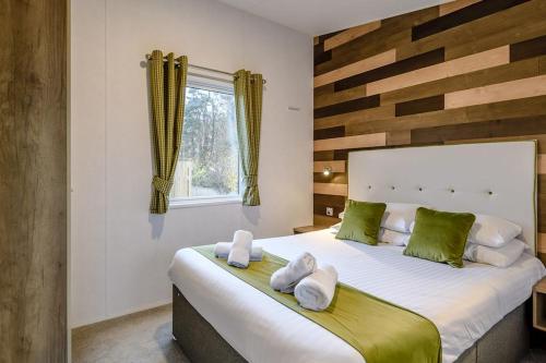 a bedroom with a large bed with towels on it at Best Western Plus Kenwick Park Hotel in Louth