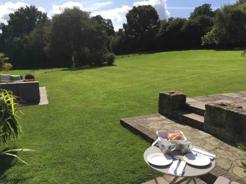 a plate of food on a table in a field at The Annex is in the beautiful Ashdown Forest in Crowborough