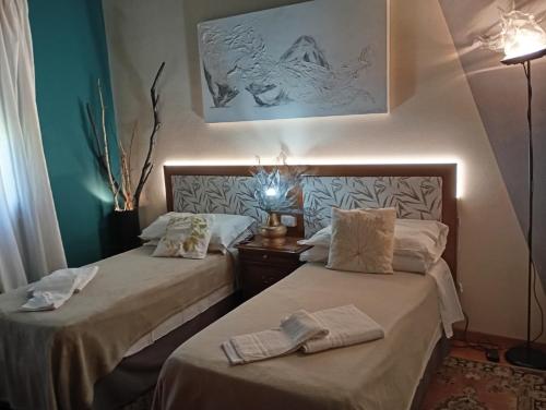 a room with two beds with towels on them at 49 Le Contesse Ide in Meolo
