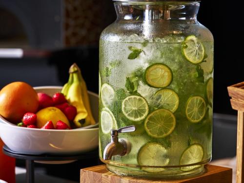 a jar of lemonade next to a bowl of fruit at Novotel Nara in Nara