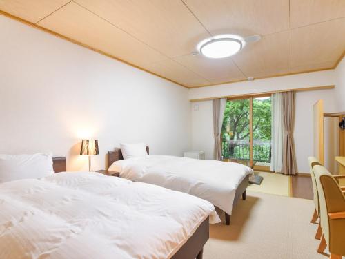 Postel nebo postele na pokoji v ubytování はなぞの温泉 花圃の里