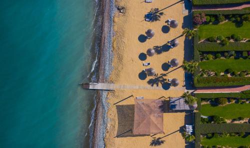 an overhead view of a beach with the ocean at Atlantis Gardens in Mazotos