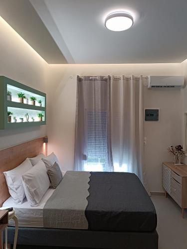 a bedroom with a large bed and a window at Roummi Suite Mirtos in Myrtos