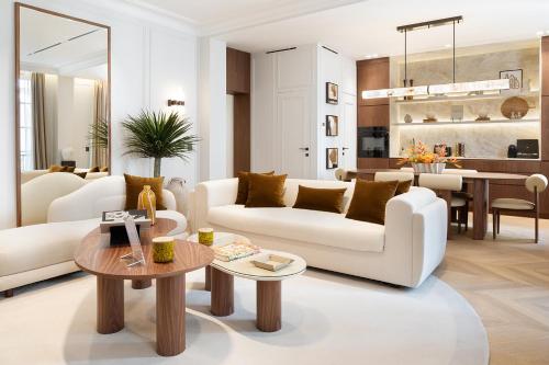 - un salon avec deux canapés blancs et une table dans l'établissement TheLander - Serviced Apartments in Opéra, à Paris