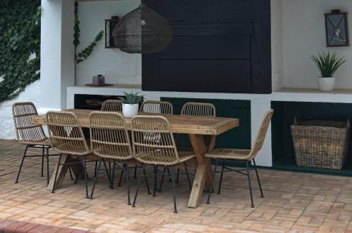 a wooden table and chairs on a patio at Killassy House in Graaff-Reinet
