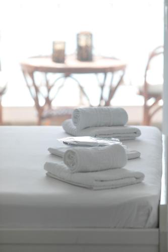 a pile of towels sitting on top of a table at Hemera House Fourka in Fourka