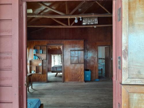 an open door into a room in an old house at Imagination Island Eco Resort in Gizo