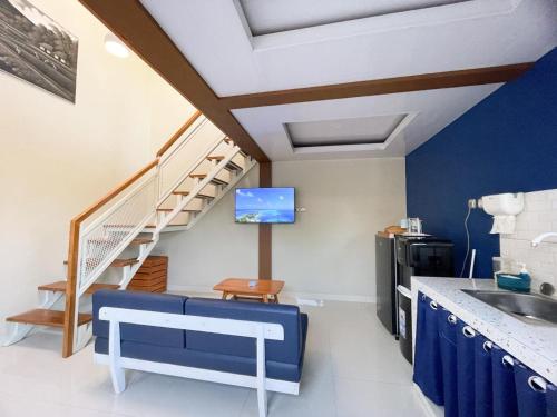 a living room with a staircase and a sink at Aso Living in Bantul