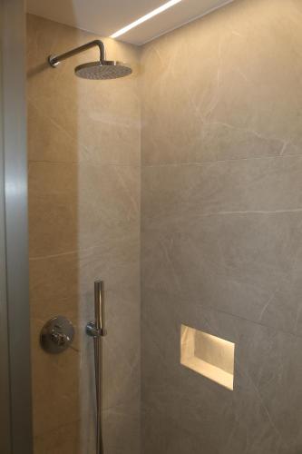 a bathroom with a shower with a glass door at Anais in Mýkonos City
