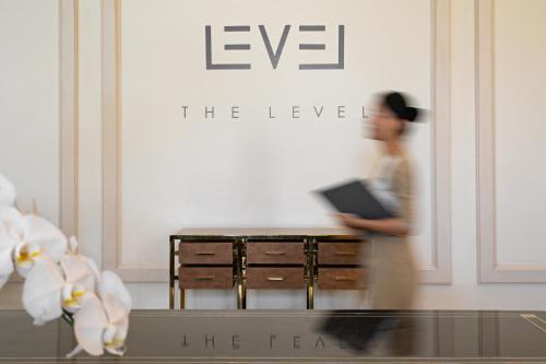 a person walking in front of a table with a laptop at Melia Vinpearl Phu Quoc in Phu Quoc