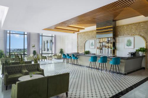 a lobby with a bar and blue stools at Melia Vinpearl Phu Quoc in Phu Quoc