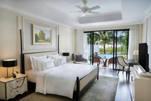 a bedroom with a bed and a living room at Melia Vinpearl Phu Quoc in Phu Quoc