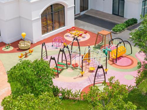 an outdoor play area with a playground with slides at Melia Vinpearl Phu Quoc in Phu Quoc