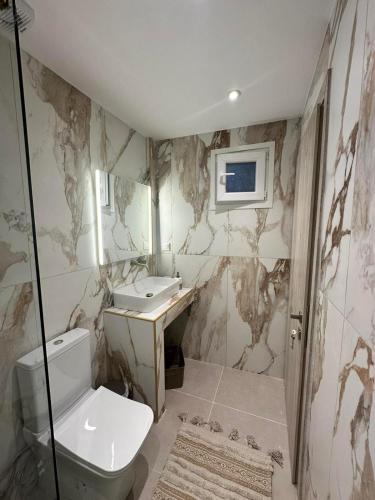 a bathroom with a toilet and a sink at Peraia Luxury Studio in Perea