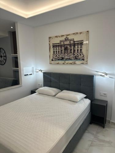 a bedroom with a large bed with two pillows at Peraia Luxury Studio in Perea