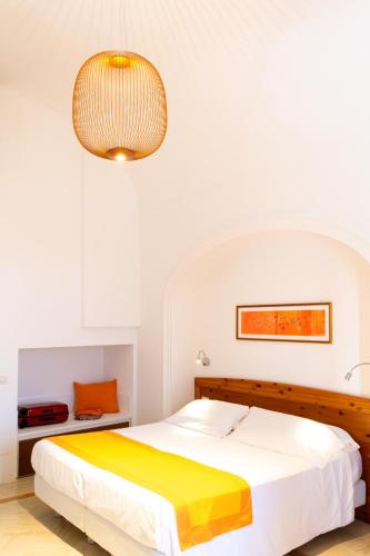 a bedroom with a bed and a chandelier at Residence Lì Galli in Praiano