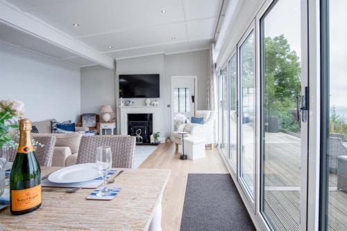 a wine bottle sitting on a table in a living room at Shearwater 30 - 2 Bedroom Lodge - Summerhill in Amroth