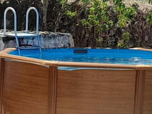 a swimming pool with a chair sitting on top of it at O Sitio da Paz in Robalo
