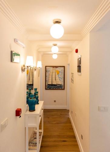 a hallway with a table with vases on it at Kairos Hotel in Siğacık