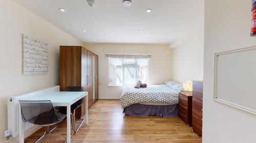 a bedroom with a bed and a desk in it at Studio29A in London