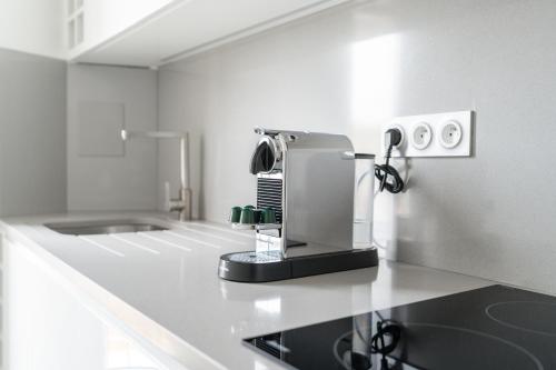 a kitchen with a coffee maker on a counter at L'Auguste - Face RER B - Free Parking in Gentilly