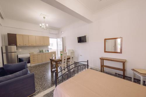 a living room with a couch and a kitchen at Koumbes home in Chania Town