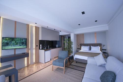 a hotel room with a bed and a couch at Shiboo Suite Otel in Gebze