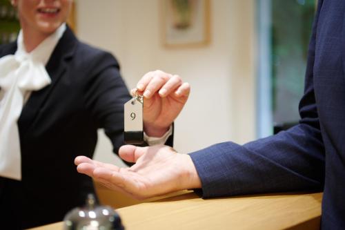 a person is holding a key in their hand at Kapellerhof in Stadl-Paura