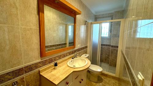 a bathroom with a sink and a toilet and a mirror at Las perlas VYBDenia in Denia