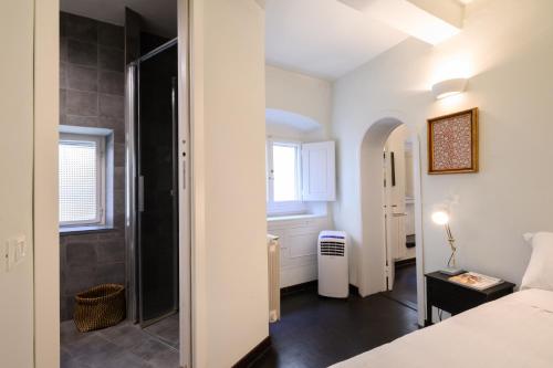 a bedroom with a bed and a walk in shower at Pitti Cozy House in Florence