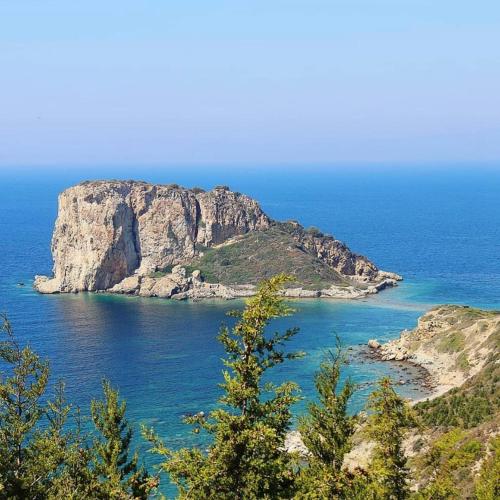 a view of a rocky island in the ocean at Kairos Hotel in Siğacık