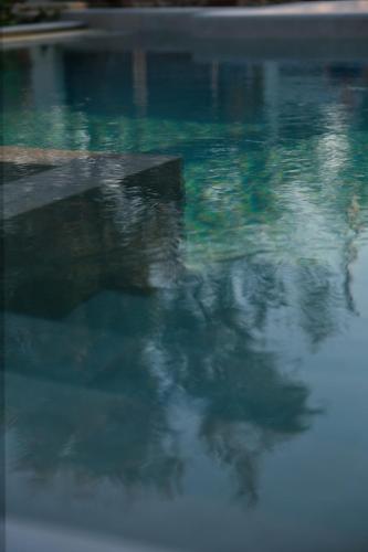 a pool of water with a reflection in the water at Villa Mourelo luxury villa in chania with private pool jacuzzi in Chania Town