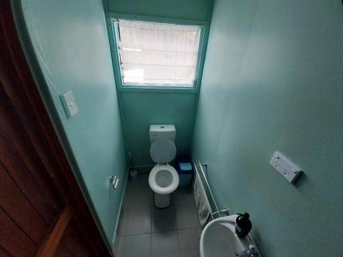 a small bathroom with a toilet and a sink at Imagination Island Eco Resort in Gizo
