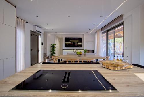 a living room with a table and a dining room at Villa Mourelo luxury villa in chania with private pool jacuzzi in Chania Town