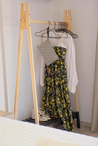 a dress hanging on a hanger in a bedroom at Villa Mourelo luxury villa in chania with private pool jacuzzi in Chania Town