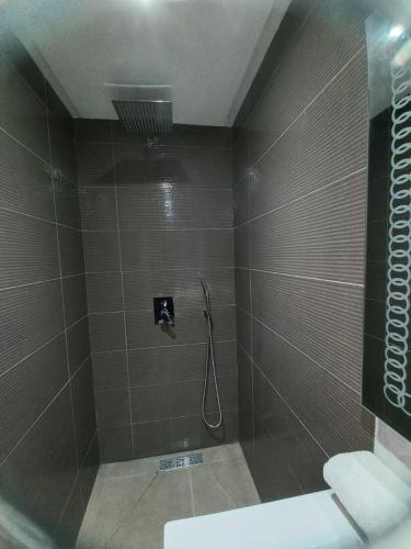 a bathroom with a shower with a toilet and a sink at SABOR FAMILY APARTS -Jaouharat Al Atlas in Marrakech