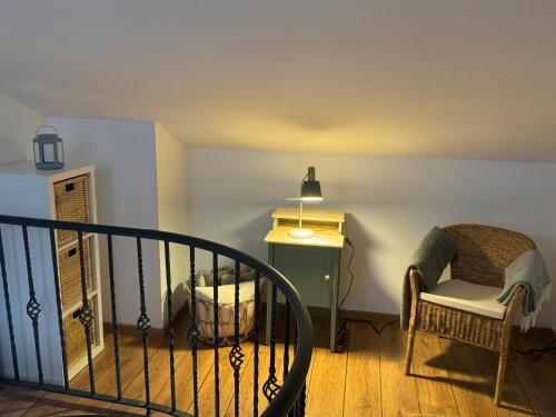 a room with a chair and a table and a lamp at Refugio Las Nieves in Puebla de Lillo