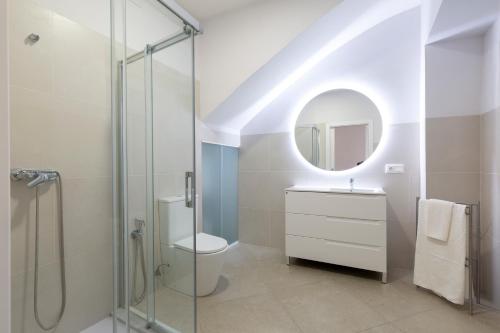 a bathroom with a toilet and a sink and a mirror at Casas De Les Roses in Orba