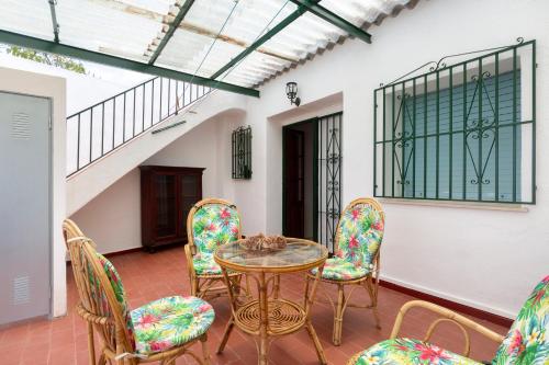 a patio with a glass table and chairs at Casas De Les Roses in Orba
