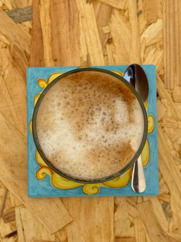 a cup of coffee sitting on top of a table at Borgo Rosalia in Galatina
