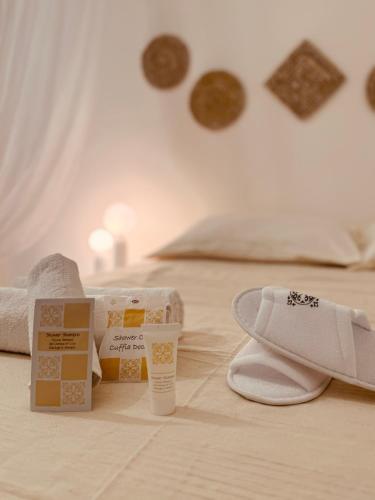 a bed with boxes and a pair of shoes on it at Borgo Rosalia in Galatina